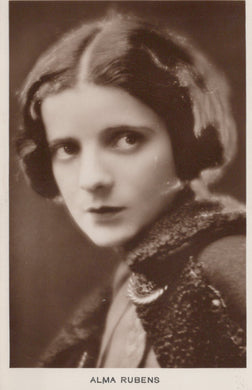 Vintage portrait of a woman with a dark bob haircut, wearing a textured garment.