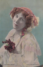 Load image into Gallery viewer, Vintage photograph of a woman in a decorative outfit with a pink bonnet and floral arrangement.
