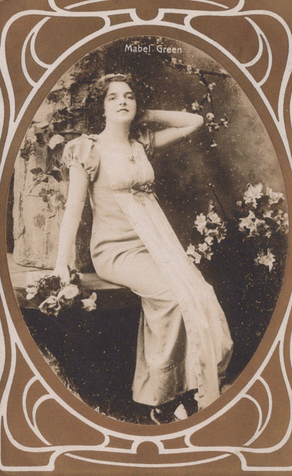 Vintage photograph of a woman in a white dress with decorative frame