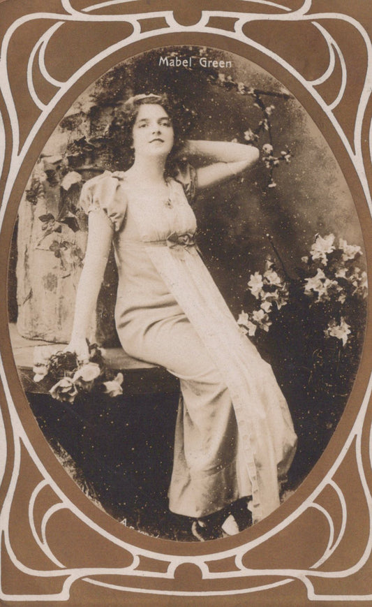 Vintage photograph of a woman in a white dress with decorative frame