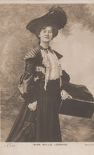 Load image into Gallery viewer, Vintage photograph of a woman in formal attire with a large hat and a fan, against a plain background.
