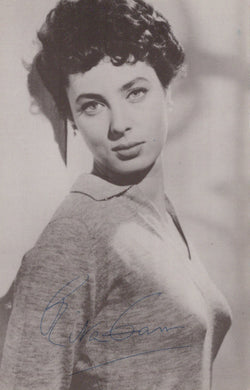 Black and white portrait of a woman wearing a sweater with a signature at the bottom.