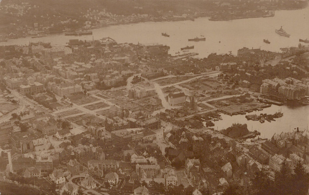 Aerial view of a city with a river and boats, vintage black and white photo