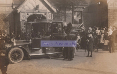 Vintage black and white photograph of a formal event with people and a horse-drawn carriage.