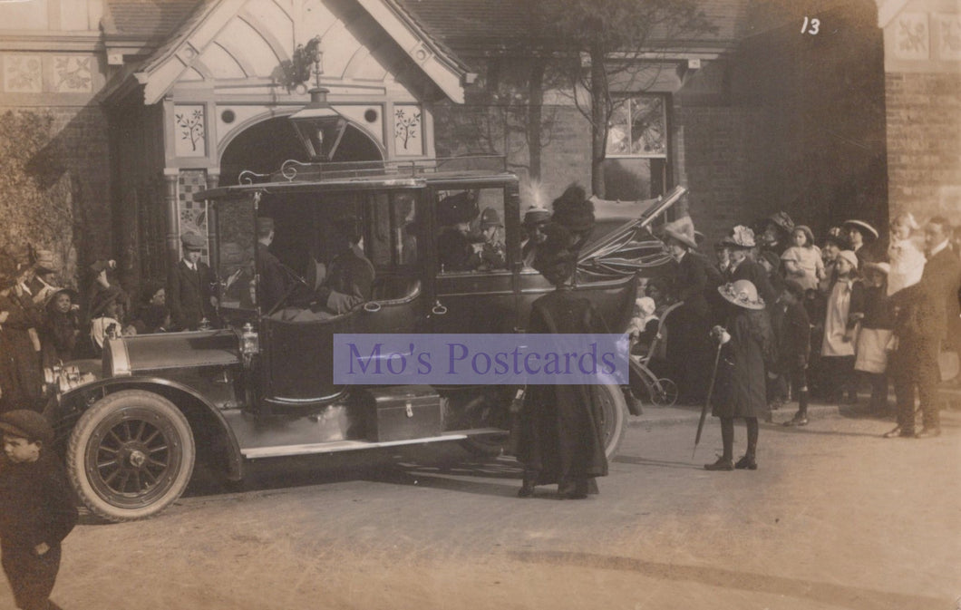 Vintage black and white photograph of a formal event with people and a horse-drawn carriage.
