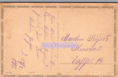 Vintage postcard with handwritten text on a beige background