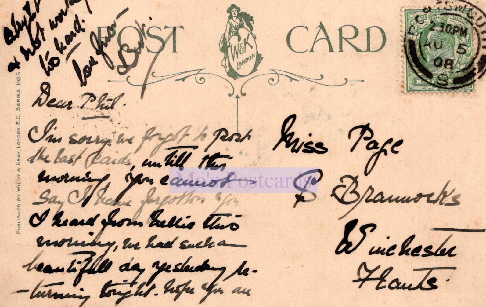 Vintage postcard with handwritten text and a stamp on a beige background