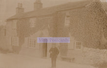 Load image into Gallery viewer, Vintage sepia-toned photograph of a man standing in front of a stone building with &#39;Mox&#39;s Postcards&#39; text overlay.
