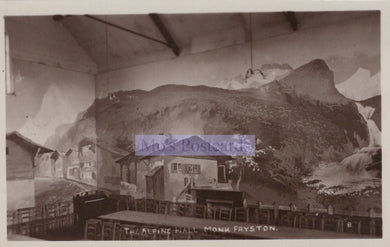 Vintage photograph of an indoor setting with a mountain mural on the wall, labeled 'The Alpine Hall, Monk Fryston'.