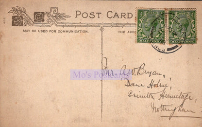 Vintage postcard with stamps and handwritten address on a beige background
