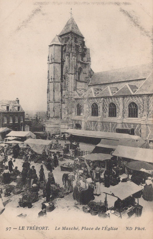 Vintage black and white photo of a market scene with a church tower in Le Tréport, France.