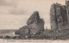 Load image into Gallery viewer, Vintage postcard of rocky cliffs at Cap Fréhel with a person standing on one of the rocks.
