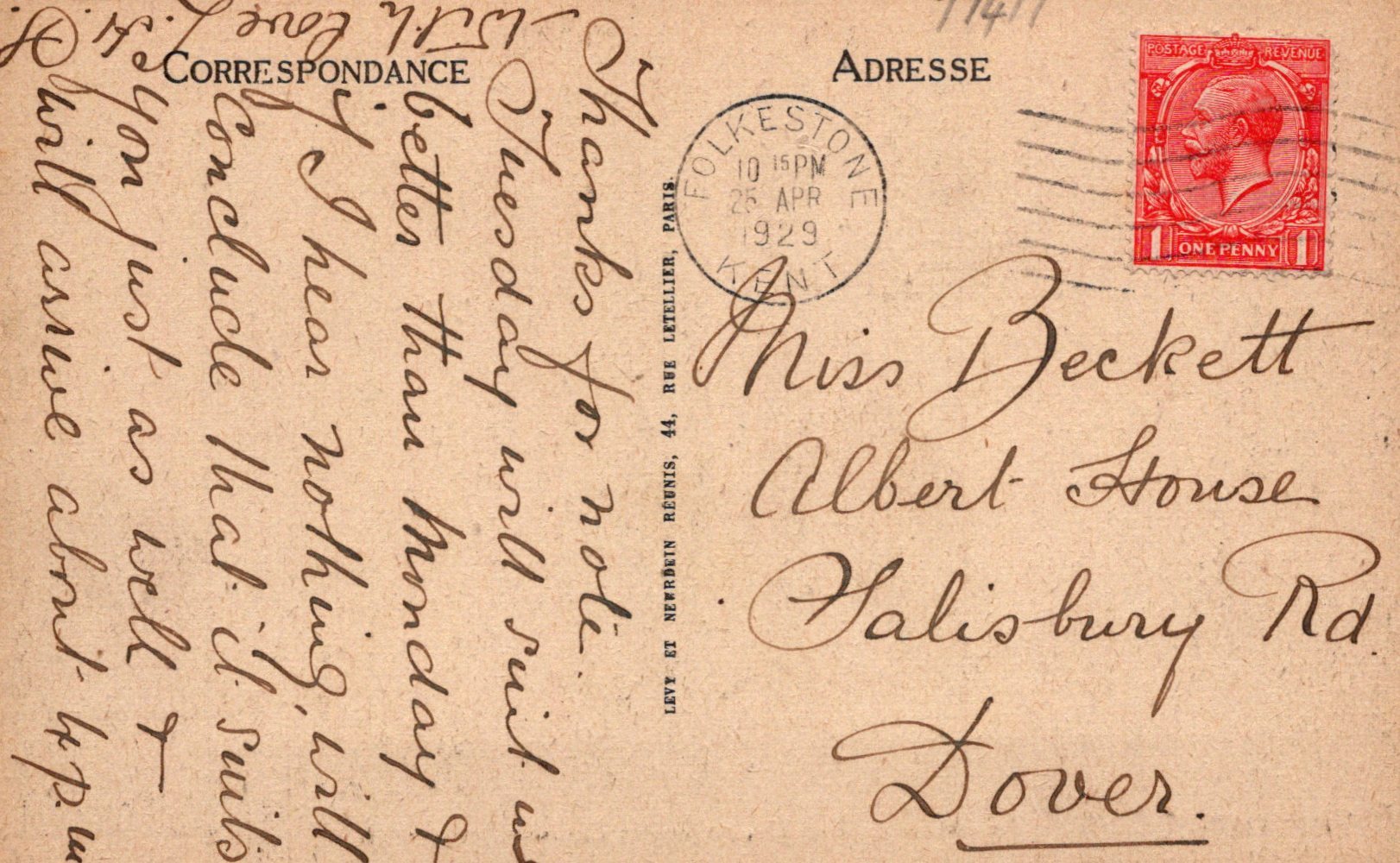 Vintage postcard with text and a red stamp, featuring a historical design.