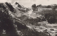 Load image into Gallery viewer, Vintage black and white photograph of a mountainous landscape with a small settlement.
