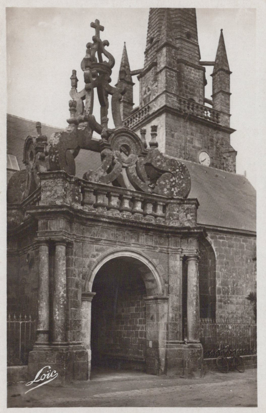 Decorative stone archway with intricate carvings in front of a building