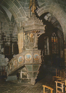 Decorative pulpit in a church with intricate carvings and statues.