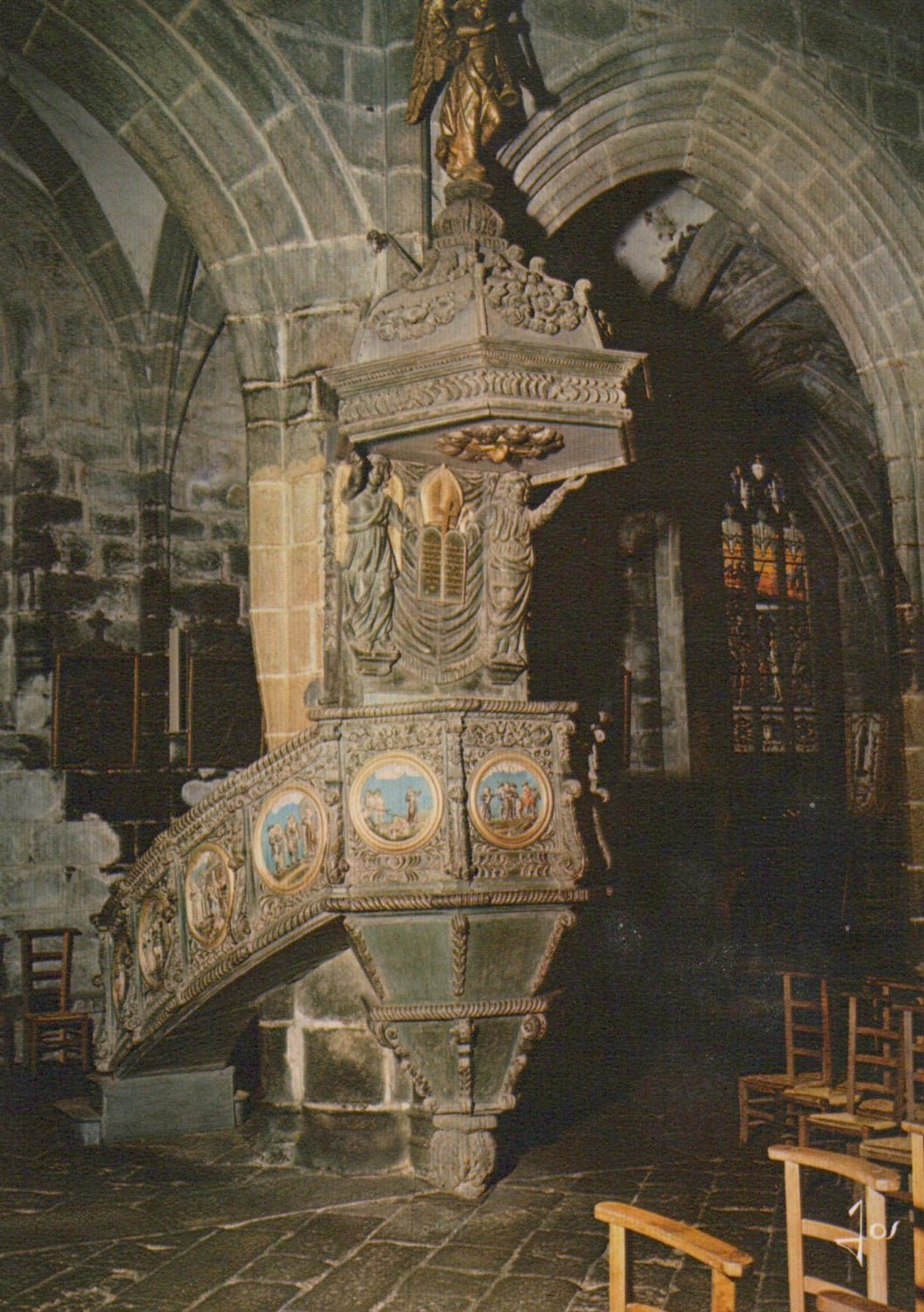 Decorative pulpit in a church with intricate carvings and statues.