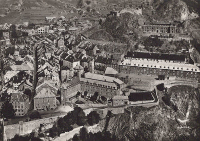 Vintage black and white aerial view of a city with historical buildings and a castle.
