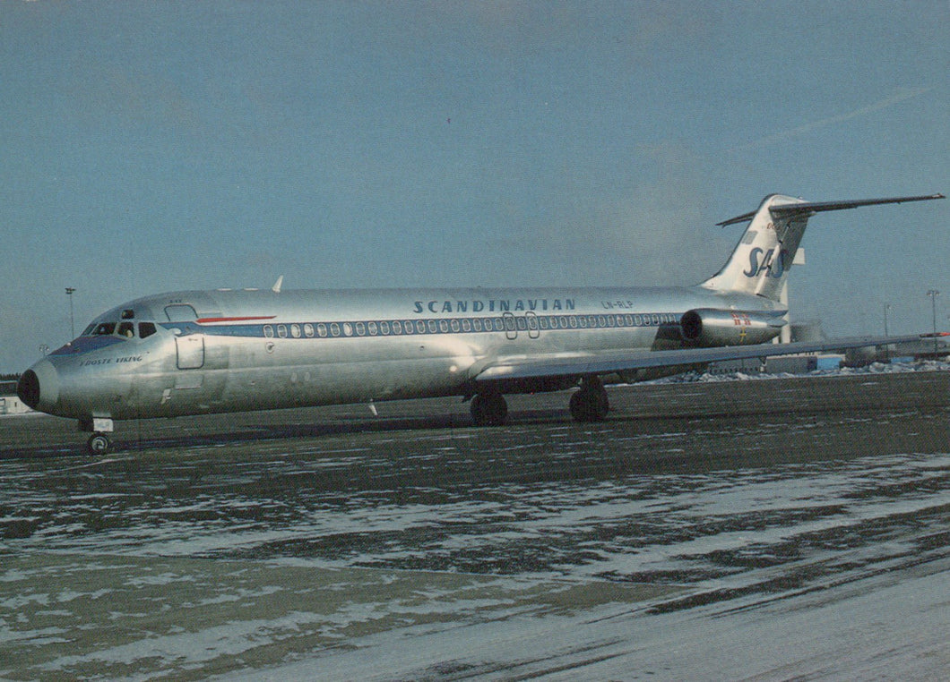 Scandinavian Airlines airplane on a runway with a clear sky background
