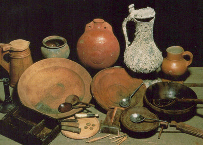 Collection of ancient pottery and utensils on a dark background