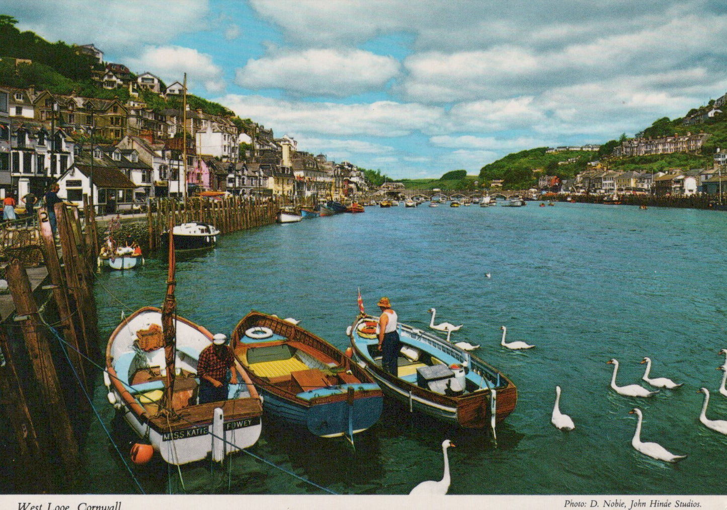 Harbor scene with boats and swans in Cornwall, UK