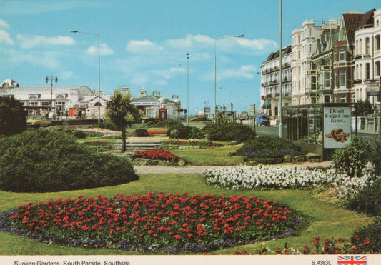Sunken Gardens with floral beds and buildings in the background