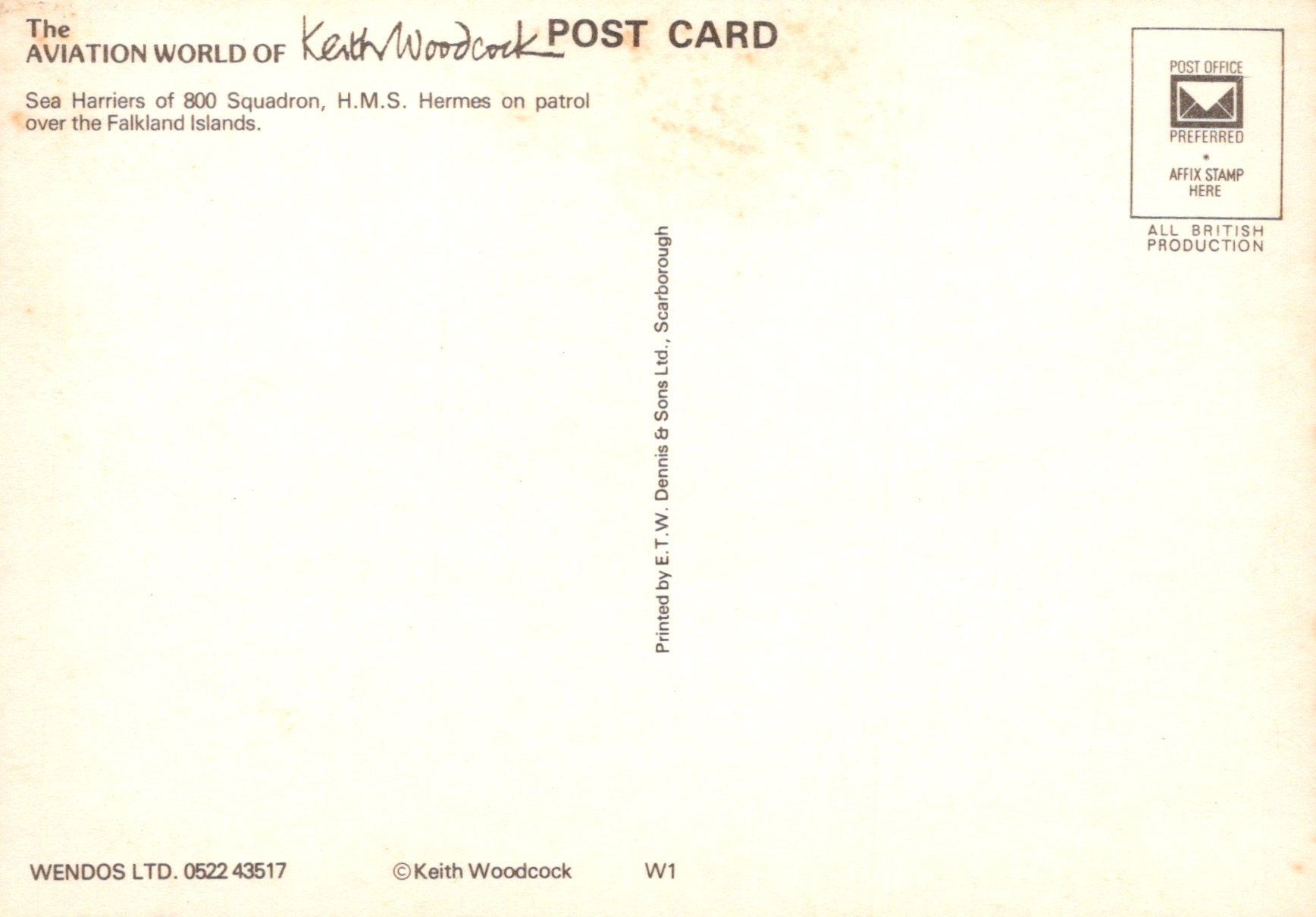 Back of a postcard with text and a logo, featuring a light yellow background.