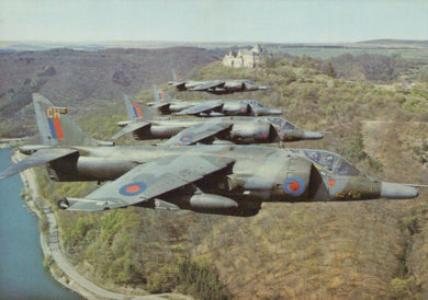 Military aircraft flying over a landscape with a castle in the background