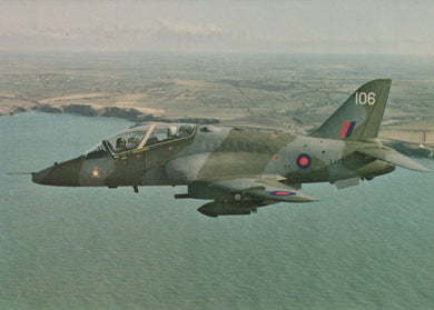 Military jet aircraft flying over a coastal landscape