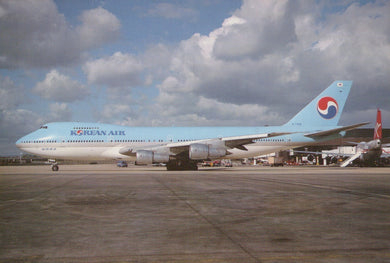 Korean Air airplane on a runway with a cloudy sky
