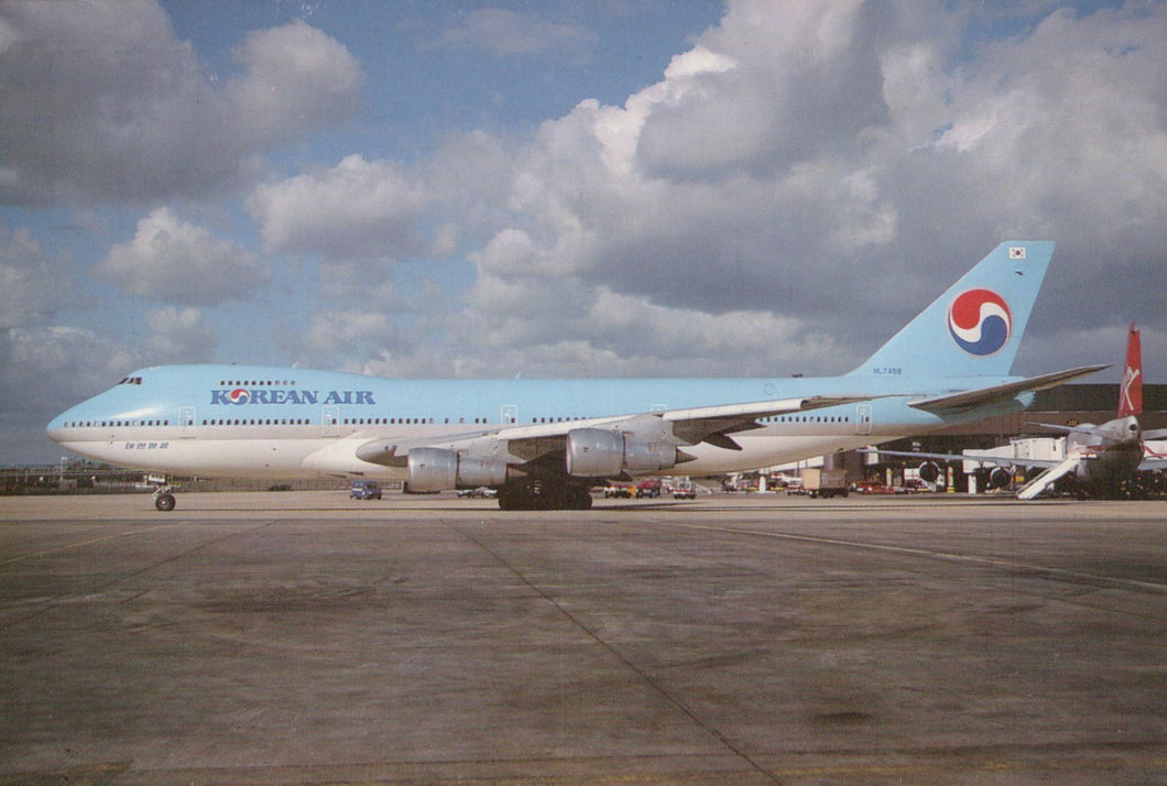 Korean Air airplane on a runway with a cloudy sky