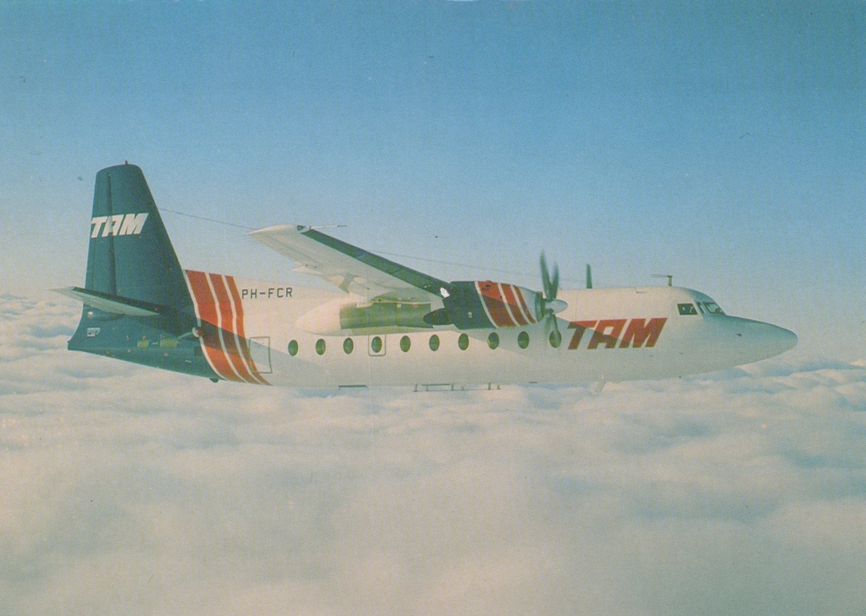 TAM airplane flying above clouds
