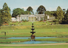 Load image into Gallery viewer, Orangery building with a fountain and garden in the foreground
