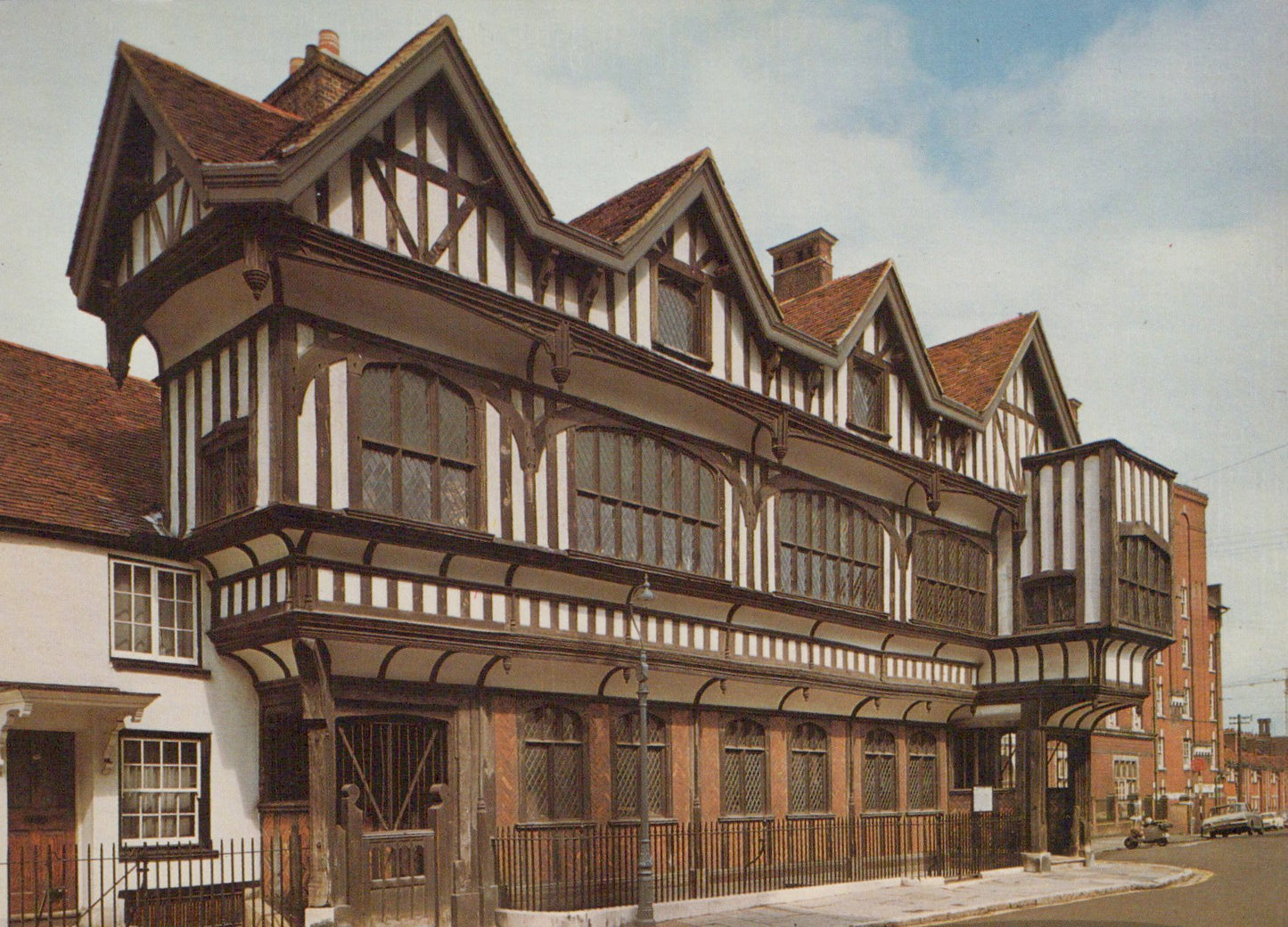 Traditional wooden building with a red roof against a blue sky.