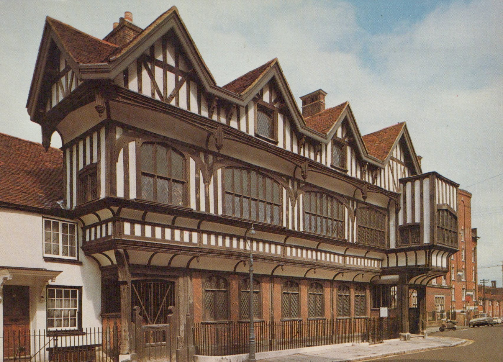 Traditional wooden building with a red roof against a blue sky.