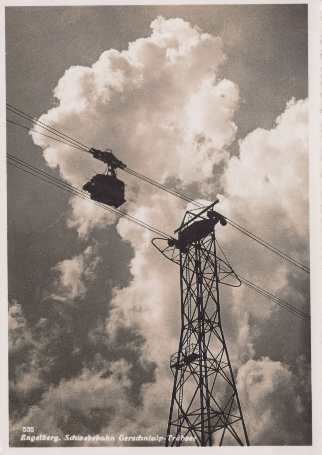 Cable car system with tower against a cloudy sky