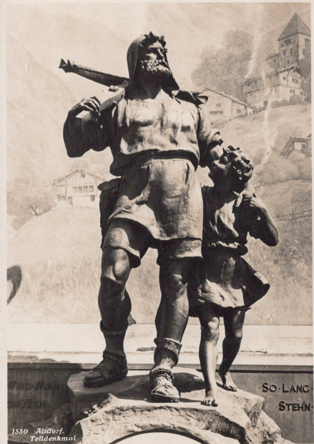 Black and white statue of a man with a child on his shoulders, with a castle in the background.