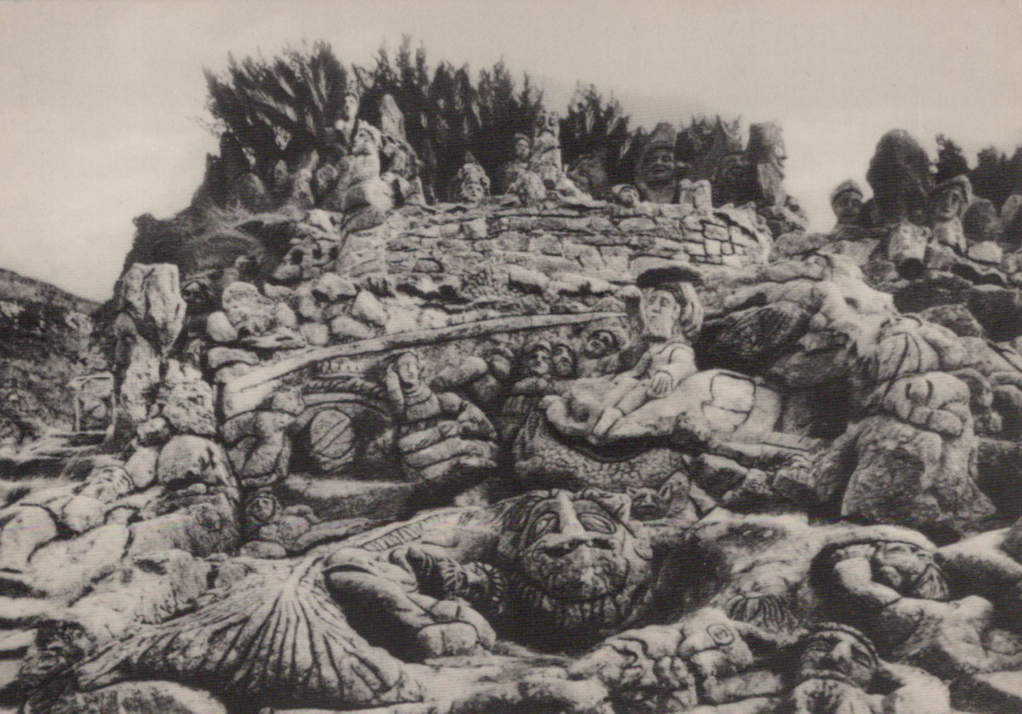 Stone sculpture of a battle scene with figures and weapons on a rocky background