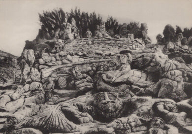 Stone sculpture of a battle scene with figures and weapons on a rocky background