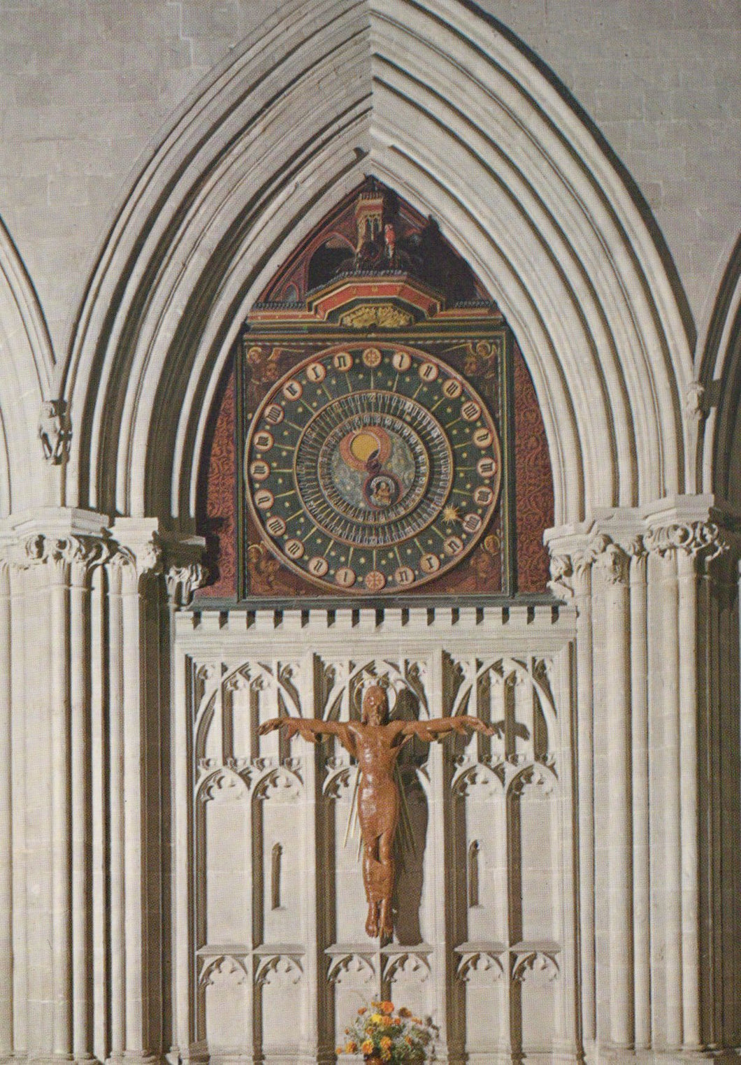 Mosaic clock and crucifixion scene in a cathedral setting