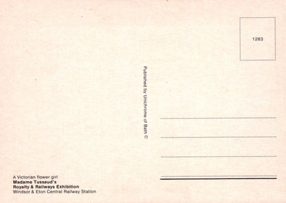Back of a postcard with text and a small square with number 1283 on a beige background