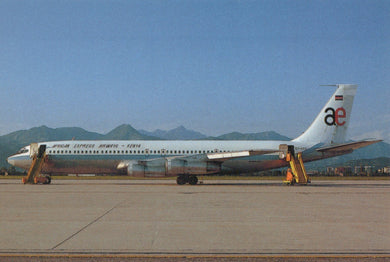 Passenger airplane on a runway with mountains in the background