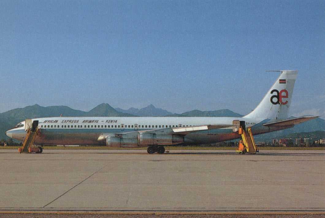 Passenger airplane on a runway with mountains in the background