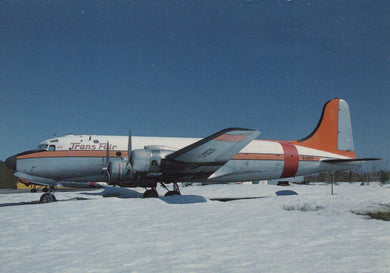 Vintage airplane with 'Trans Air' branding on a snowy ground
