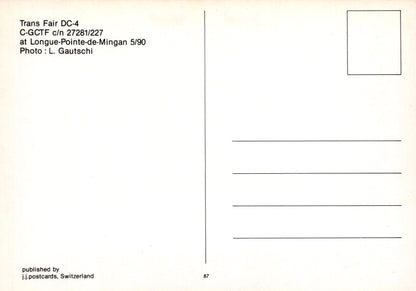 Back of a postcard with text and a small square area for a photo, featuring a light beige background.