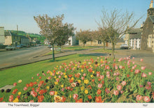 Load image into Gallery viewer, Town street with colorful flowers in the foreground
