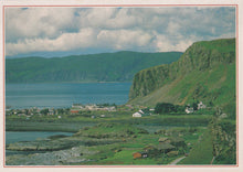Load image into Gallery viewer, Scenic view of a coastal landscape with green hills and a body of water.
