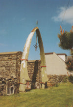 Load image into Gallery viewer, Large whalebone arch with a house and garden in the background
