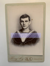 Load image into Gallery viewer, Vintage portrait of a young man in a sailor suit with &#39;Henry Levy&#39; branding on a white background.
