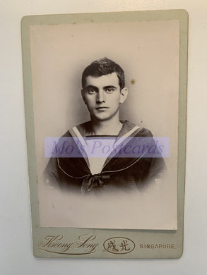 Vintage portrait of a young man in a sailor suit with 'Henry Levy' branding on a white background.
